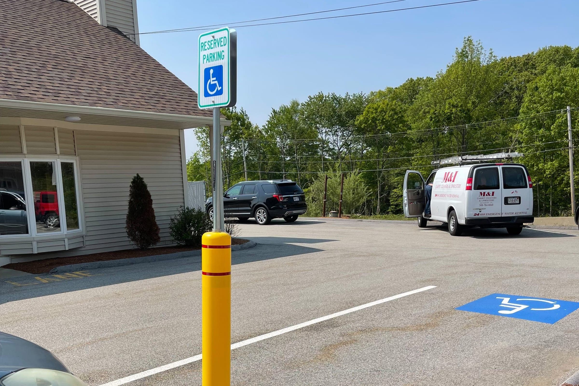 The MICS van in a parking lot beside a single-story office building.