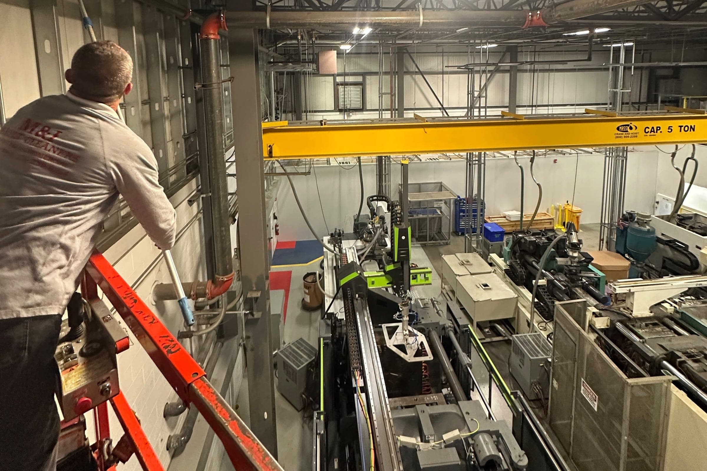 A technician on a lift inside a plant.